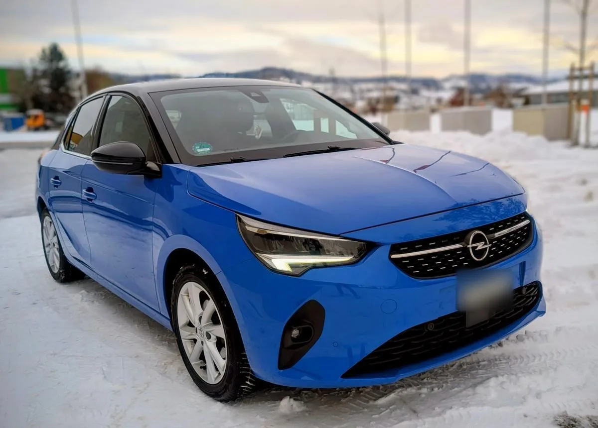 A blue Opel Corsa parked in the snow